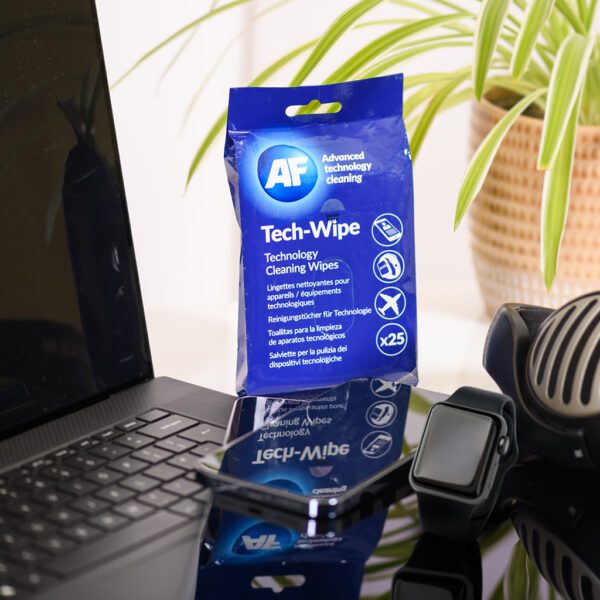Tech Wipes - Cleaning Wipes for Electronic Technology Devices - x25 MTW025P on a laptop next to a plant.