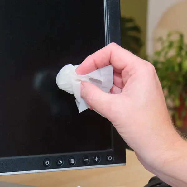 A person wiping a computer screen with Screen-Clene - Individual Screen Cleaning Wipes - x100 SCS100.