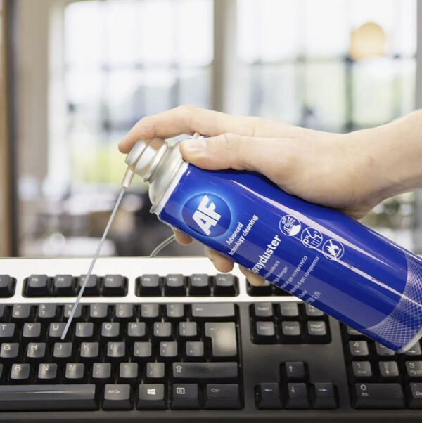 Hand cleaning keyboard with compressed air.