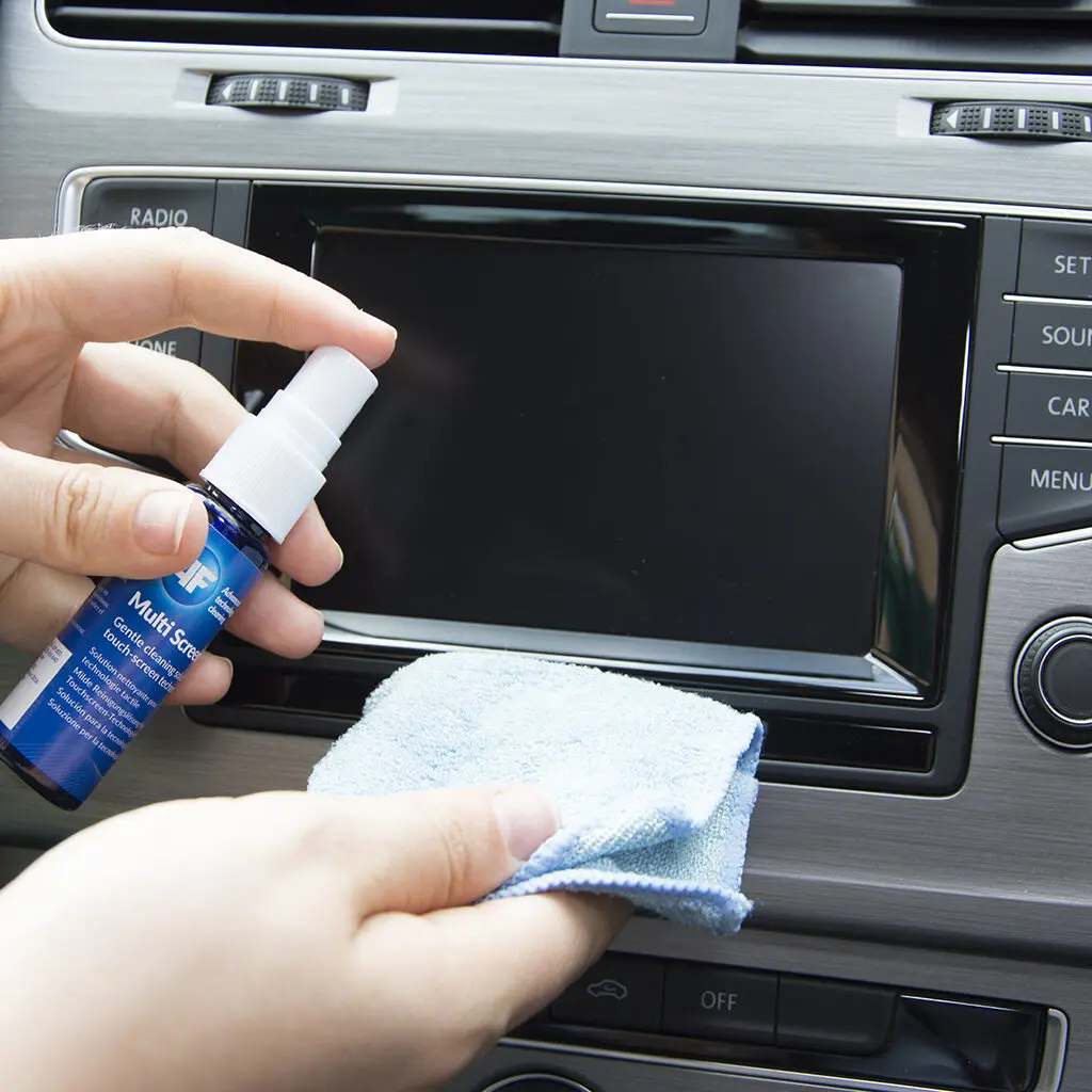 A person cleaning a car with Multi-Screen Clene - Gentle Screen Cleaning Solution Travel Size - 25ml XMCA025.