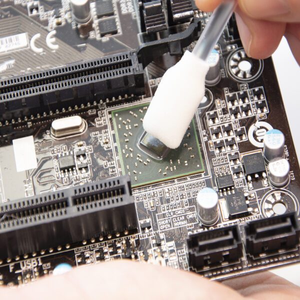 A person is using Foambuds - IPA Cleaning Solution Foam Buds - x25 FBUIPA25 to clean a motherboard.