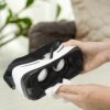 Cleaning a white VR headset with a cloth.