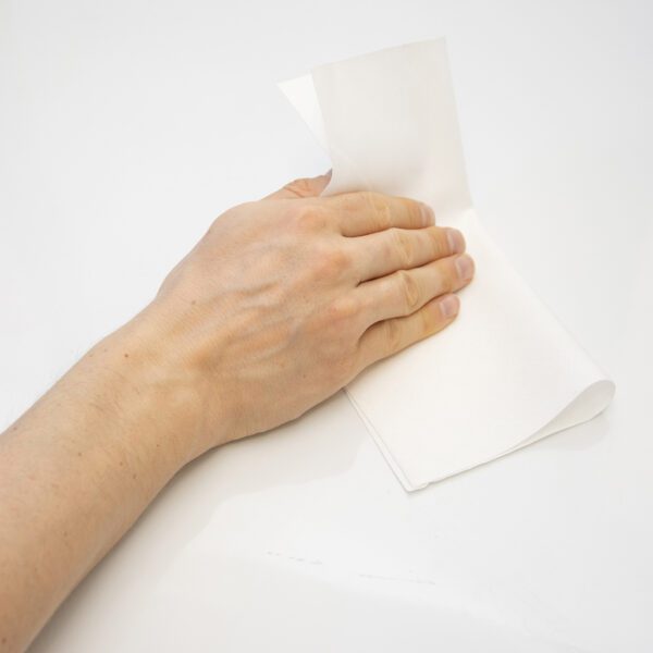 A person's hand is holding a Safewipes - Pure Cotton Wipe - SWI100.