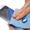 Hand cleaning phone screen with microfiber cloth.