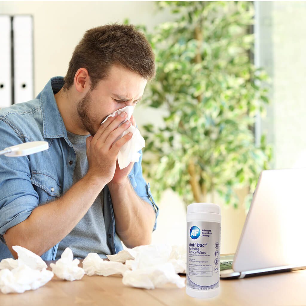 man sneezing using AF wipes